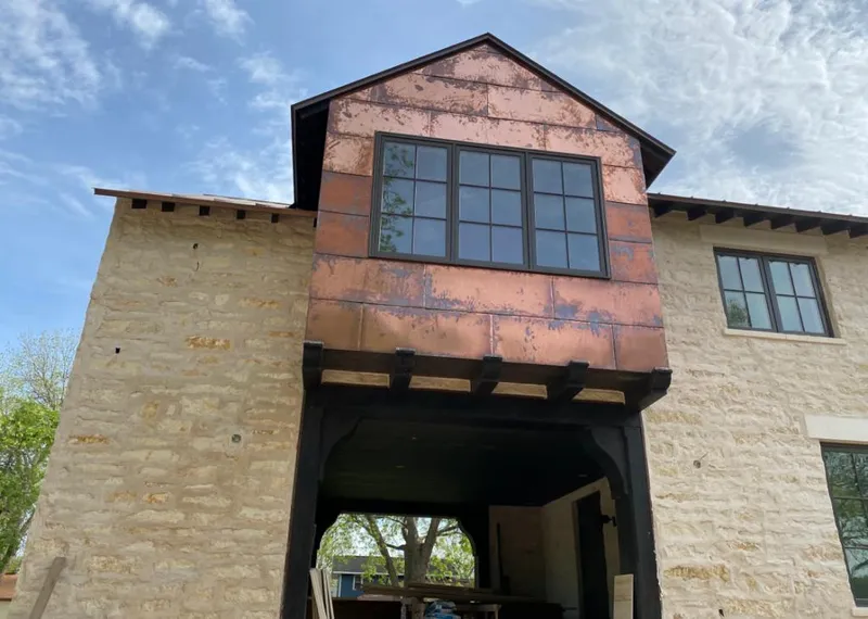 Copper metal panel facade on a stone building for Skylight Installation in Clemson