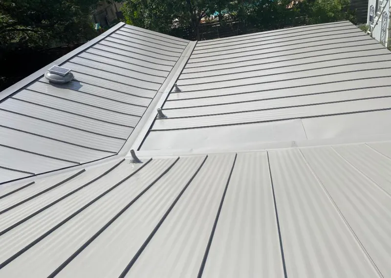 Solar attic fan installed on a metal roof for Roof Ventilation in Clemson